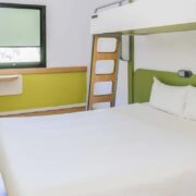 Chambre avec un lit double et un lit suspendu au sein de l'hôtel l'Ibis Budget à Gérone.